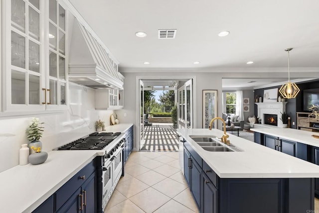 6257 Alverton, Carlsbad, CA 92009 - kitchen featuring double oven range, blue cabinets, a lit fireplace, ornamental molding, and light countertops