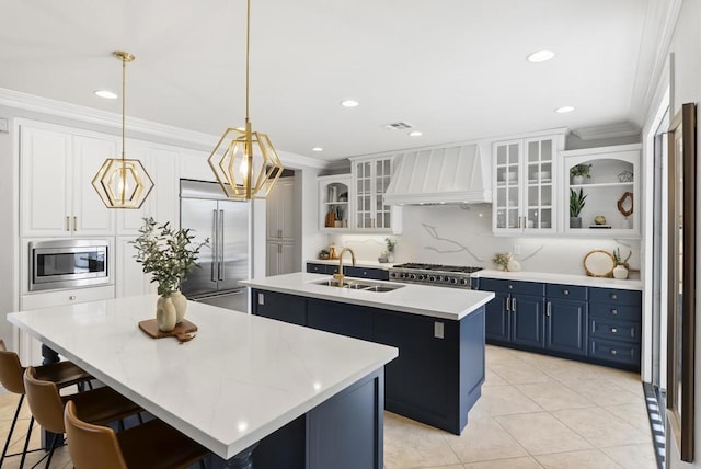 6257 Alverton, Carlsbad, CA 92009 - kitchen featuring an island with sink, custom range hood, built in appliances, ornamental molding, and blue cabinets