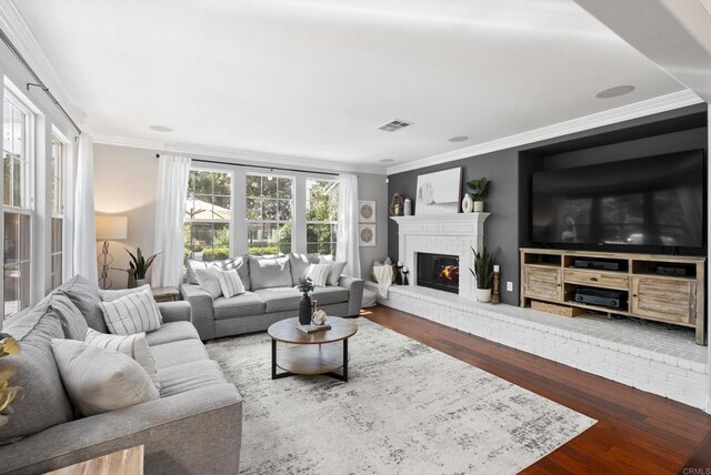 6257 Alverton, Carlsbad, CA 92009 - living room with wood finished floors, crown molding, and a brick fireplace
