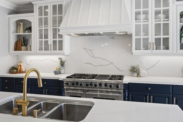 6257 Alverton, Carlsbad, CA 92009 - kitchen with blue cabinetry, premium range hood, range with two ovens, glass insert cabinets, and ornamental molding