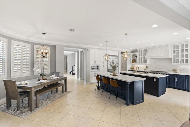6257 Alverton, Carlsbad, CA 92009 - kitchen with premium range hood, a kitchen island with sink, light countertops, a chandelier, and recessed lighting