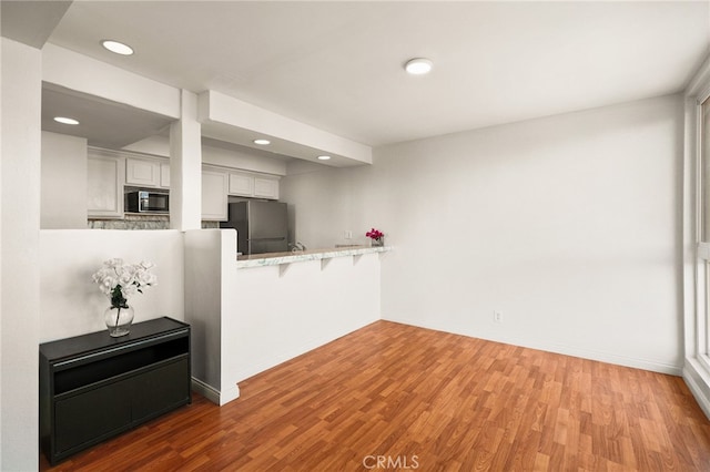 911 N Kings Rd Unit 310, West Hollywood, CA 90069 - unfurnished living room with wood finished floors and recessed lighting