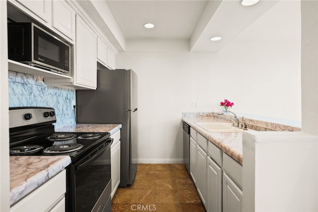 911 N Kings Rd Unit 310, West Hollywood, CA 90069 - kitchen with black appliances, white cabinetry, decorative backsplash, recessed lighting, and light countertops