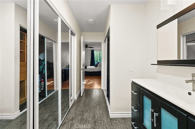 911 N Kings Rd Unit 310, West Hollywood, CA 90069 - bathroom with wood finished floors, vanity, connected bathroom, and ceiling fan