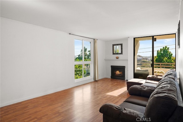 911 N Kings Rd Unit 310, West Hollywood, CA 90069 - living room featuring a warm lit fireplace and wood finished floors