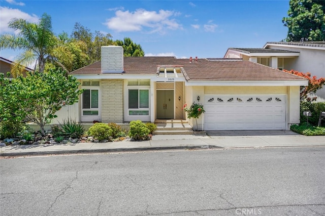 5022 Tamarack Way, Irvine, CA 92612 - view of front of property with a chimney, a garage, driveway, and a tiled roof