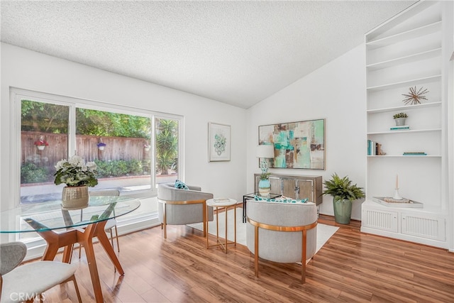 5022 Tamarack Way, Irvine, CA 92612 - dining space with a textured ceiling, wood finished floors, vaulted ceiling, and built in features