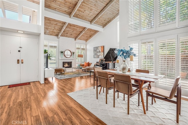 5022 Tamarack Way, Irvine, CA 92612 - dining area featuring high vaulted ceiling, a wood ceiling with exposed beams, wood finished floors, and a brick fireplace
