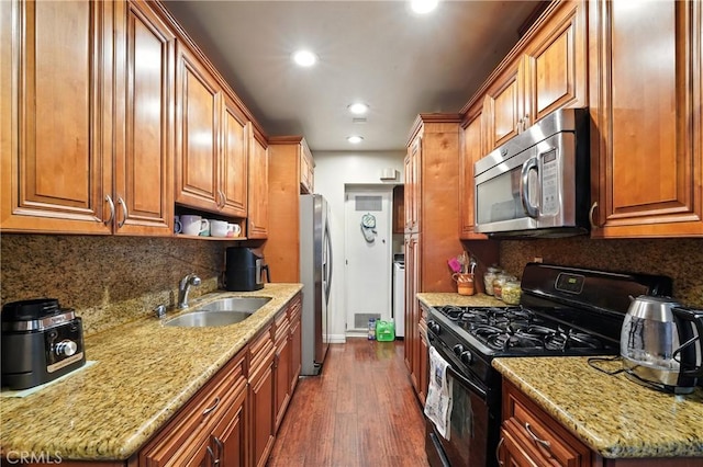 1459 Fredericks Ln, Upland, CA 91786 - kitchen with appliances with stainless steel finishes, dark wood-style floors, recessed lighting, light stone countertops, and decorative backsplash