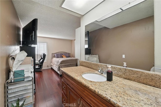 1459 Fredericks Ln, Upland, CA 91786 - bathroom with vanity, wood finished floors, and a textured ceiling