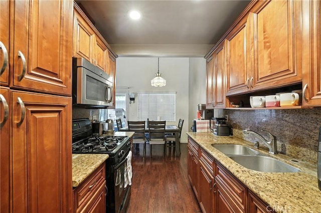 1459 Fredericks Ln, Upland, CA 91786 - kitchen with stainless steel microwave, black range with gas stovetop, tasteful backsplash, dark wood-style flooring, and light stone countertops