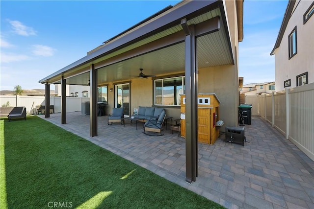 19465 Brush Creek Way, Lake Elsinore, CA 92532 - back of property featuring a ceiling fan, a patio area, a fenced backyard, an outdoor living space, and stucco siding