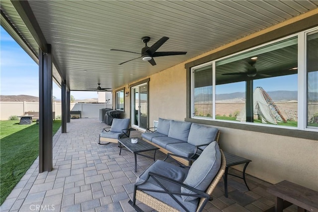 19465 Brush Creek Way, Lake Elsinore, CA 92532 - view of patio with a ceiling fan, an outdoor living space, and a mountain view