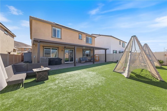 19465 Brush Creek Way, Lake Elsinore, CA 92532 - rear view of property with a fenced backyard, a patio area, stucco siding, and an outdoor living space with a fire pit