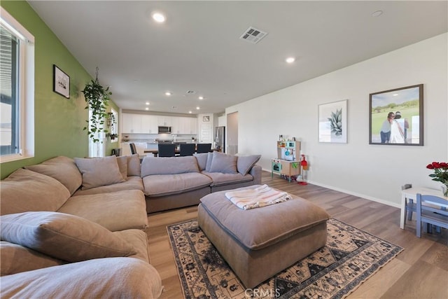 19465 Brush Creek Way, Lake Elsinore, CA 92532 - living area featuring light wood-style floors and recessed lighting