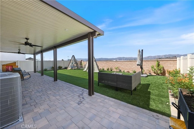 19465 Brush Creek Way, Lake Elsinore, CA 92532 - fenced backyard featuring a playground, a patio area, ceiling fan, an outdoor living space, and a mountain view