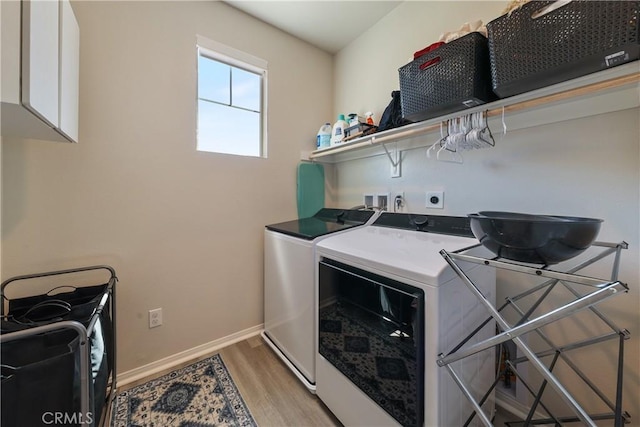 19465 Brush Creek Way, Lake Elsinore, CA 92532 - washroom with washing machine and dryer and light wood-style floors