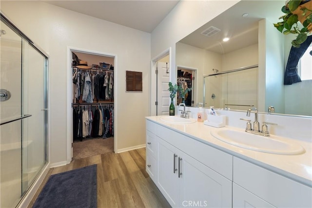 19465 Brush Creek Way, Lake Elsinore, CA 92532 - full bathroom with wood finished floors, a stall shower, a spacious closet, and double vanity