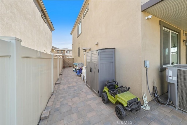 19465 Brush Creek Way, Lake Elsinore, CA 92532 - view of property exterior featuring stucco siding, a fenced backyard, and a patio area
