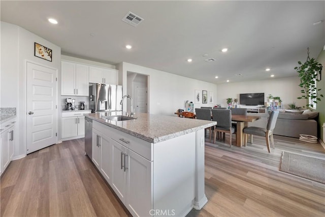 19465 Brush Creek Way, Lake Elsinore, CA 92532 - kitchen featuring appliances with stainless steel finishes, light wood-type flooring, white cabinetry, and recessed lighting