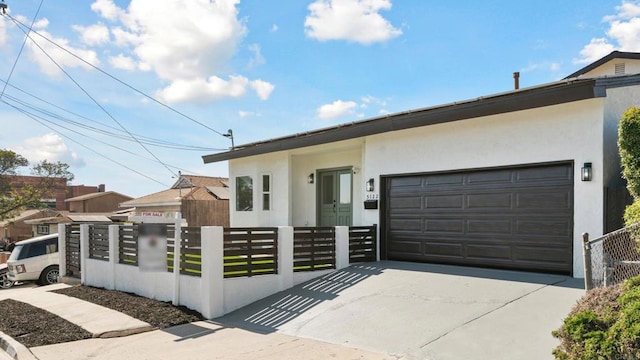 5122 Coban St, San Diego, CA 92114 - view of front of house featuring concrete driveway, a fenced front yard, a garage, and stucco siding