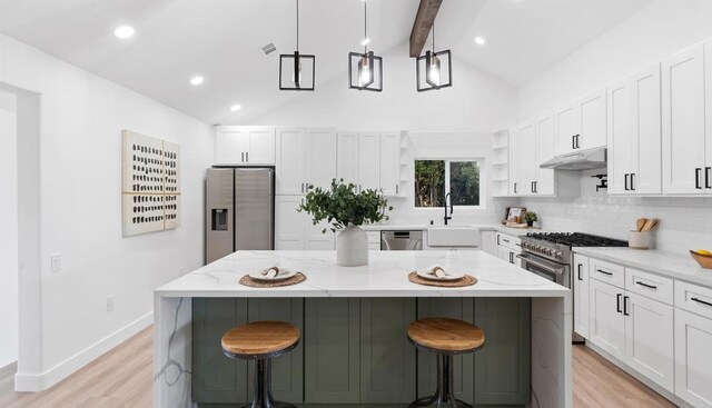 5122 Coban St, San Diego, CA 92114 - kitchen featuring stainless steel appliances, under cabinet range hood, open shelves, tasteful backsplash, and a kitchen island