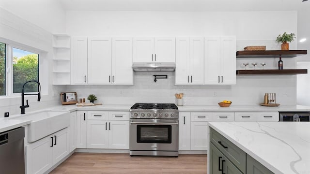 5122 Coban St, San Diego, CA 92114 - kitchen with open shelves, appliances with stainless steel finishes, under cabinet range hood, light stone countertops, and white cabinetry
