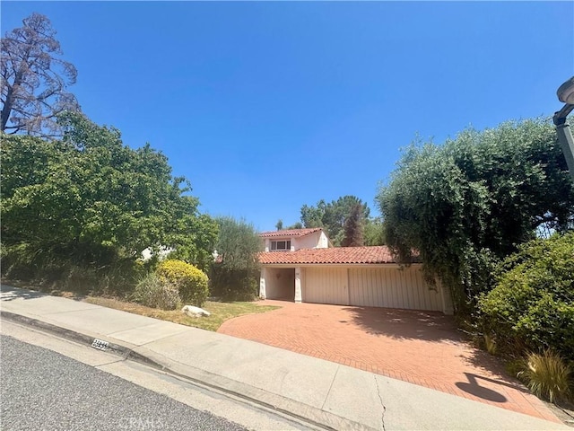 23135 Park Contessa, Calabasas, CA 91302 - mediterranean / spanish-style house with a tile roof, decorative driveway, and stucco siding
