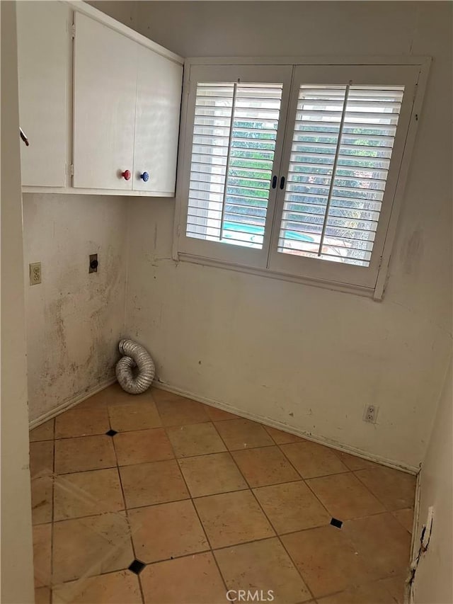 23135 Park Contessa, Calabasas, CA 91302 - laundry area featuring hookup for an electric dryer, cabinet space, and light tile patterned floors