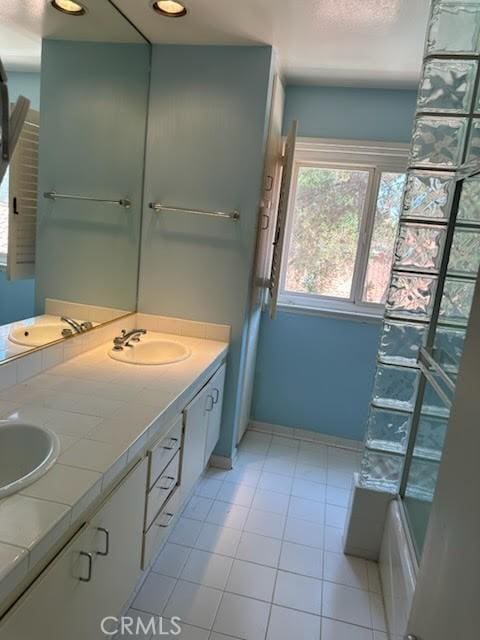 23135 Park Contessa, Calabasas, CA 91302 - full bath featuring double vanity, tile patterned flooring, and a bathtub