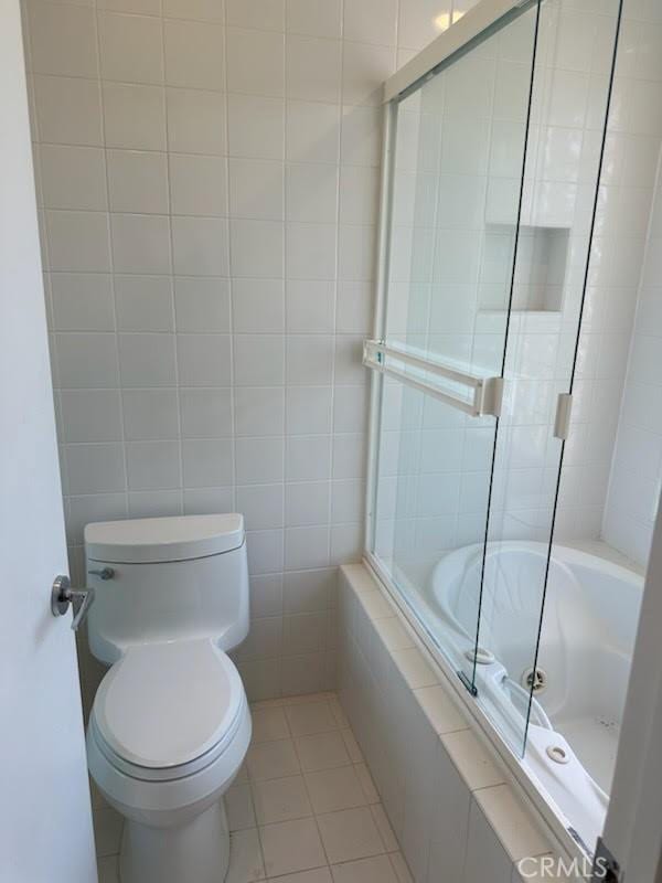 23135 Park Contessa, Calabasas, CA 91302 - bathroom with tiled shower / bath, tile patterned flooring, and tile walls