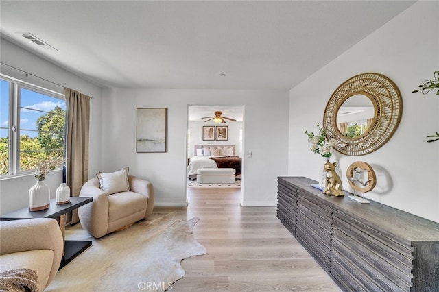 9370 Bistro Pl, Rancho Cucamonga, CA 91730 - living room with light wood-style floors and a ceiling fan
