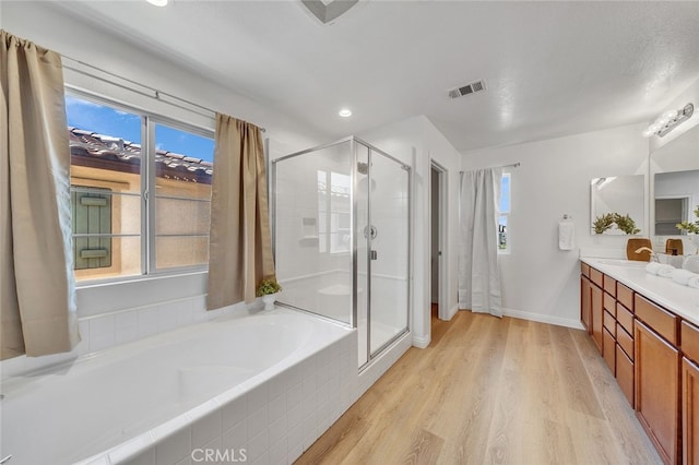 9370 Bistro Pl, Rancho Cucamonga, CA 91730 - full bath with vanity, a shower stall, a bath, wood finished floors, and recessed lighting