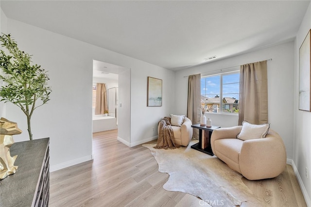9370 Bistro Pl, Rancho Cucamonga, CA 91730 - living area with light wood-style flooring and baseboards
