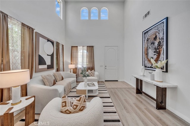 9370 Bistro Pl, Rancho Cucamonga, CA 91730 - living room featuring a high ceiling and light wood-style flooring