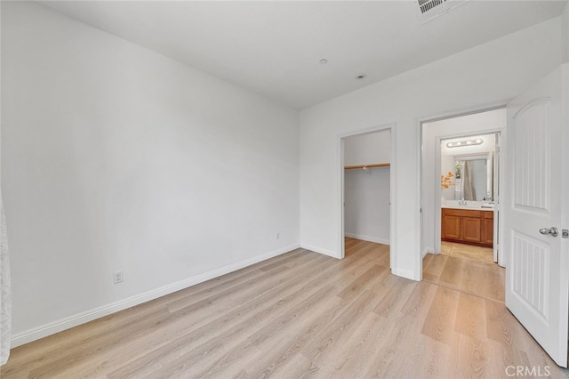 9370 Bistro Pl, Rancho Cucamonga, CA 91730 - unfurnished bedroom featuring light wood-style flooring and a walk in closet