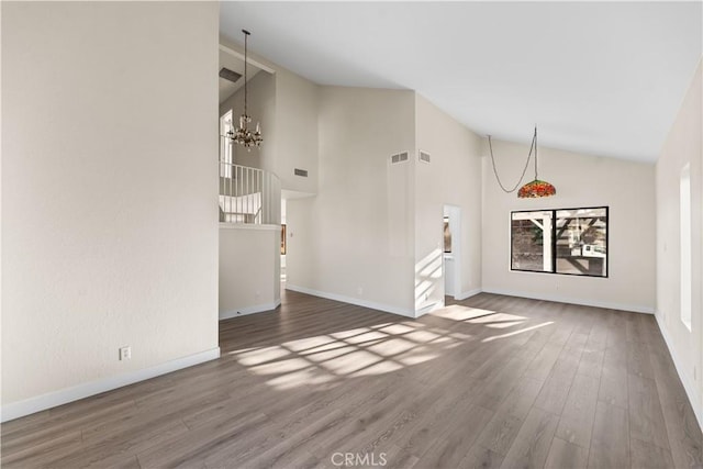 36647 Apache Plume Dr, Palmdale, CA 93550 - unfurnished living room featuring a chandelier, wood finished floors, and high vaulted ceiling