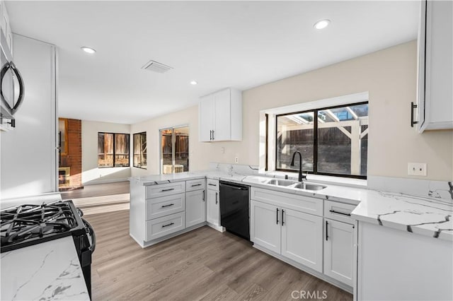 36647 Apache Plume Dr, Palmdale, CA 93550 - kitchen featuring black appliances, light wood-style floors, white cabinets, light stone countertops, and recessed lighting
