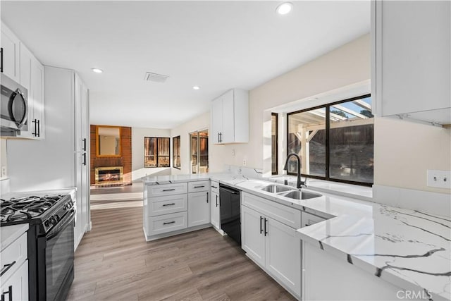 36647 Apache Plume Dr, Palmdale, CA 93550 - kitchen featuring black appliances, white cabinets, a peninsula, light wood-style floors, and recessed lighting