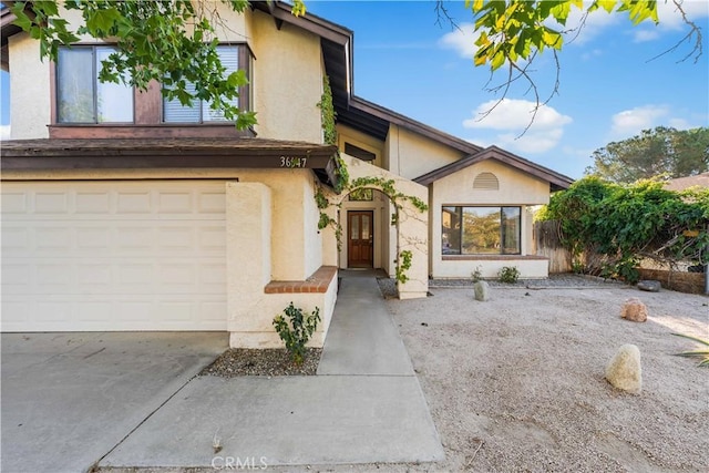 36647 Apache Plume Dr, Palmdale, CA 93550 - view of front of house with stucco siding, an attached garage, and driveway