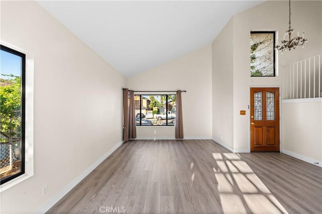 36647 Apache Plume Dr, Palmdale, CA 93550 - entryway featuring high vaulted ceiling, light wood-style flooring, and a chandelier