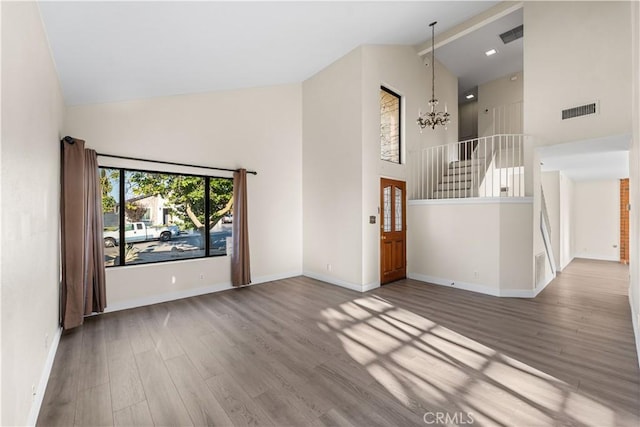 36647 Apache Plume Dr, Palmdale, CA 93550 - unfurnished living room featuring high vaulted ceiling, a chandelier, wood finished floors, stairs, and beamed ceiling