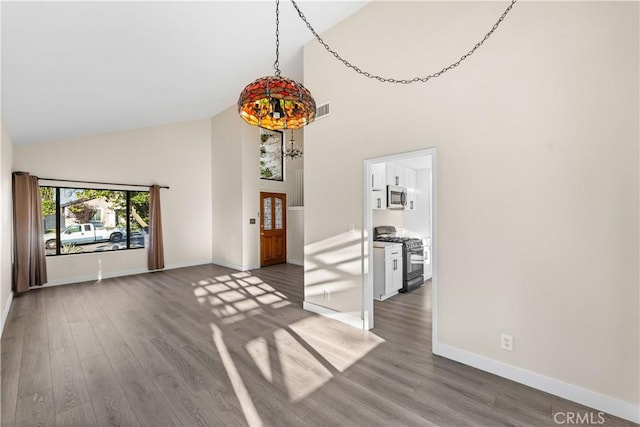 36647 Apache Plume Dr, Palmdale, CA 93550 - unfurnished living room featuring high vaulted ceiling and wood finished floors