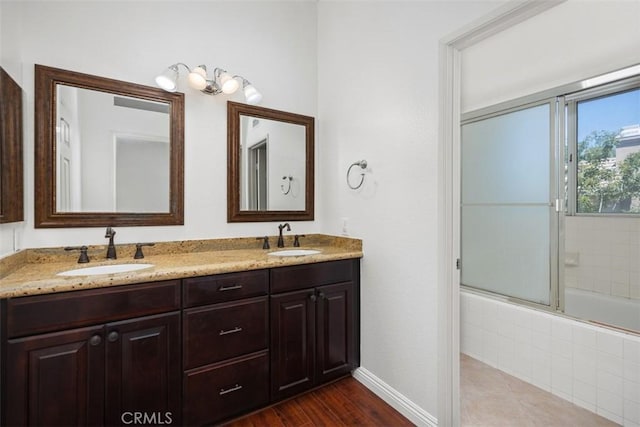 15 Havre Ct, Lake Forest, CA 92610 - bathroom with tiled shower / bath combo, double vanity, and wood finished floors
