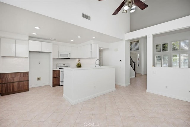 15 Havre Ct, Lake Forest, CA 92610 - kitchen featuring white appliances, backsplash, white cabinetry, light countertops, and a ceiling fan