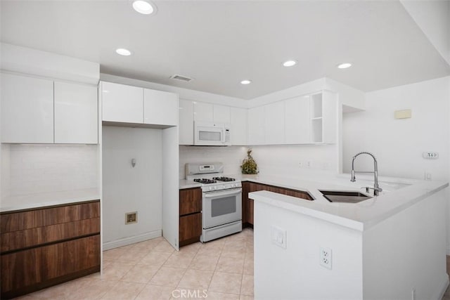15 Havre Ct, Lake Forest, CA 92610 - kitchen with white appliances, a peninsula, open shelves, white cabinets, and decorative backsplash