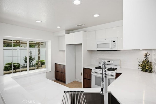 15 Havre Ct, Lake Forest, CA 92610 - kitchen with white appliances, white cabinetry, decorative backsplash, recessed lighting, and modern cabinets