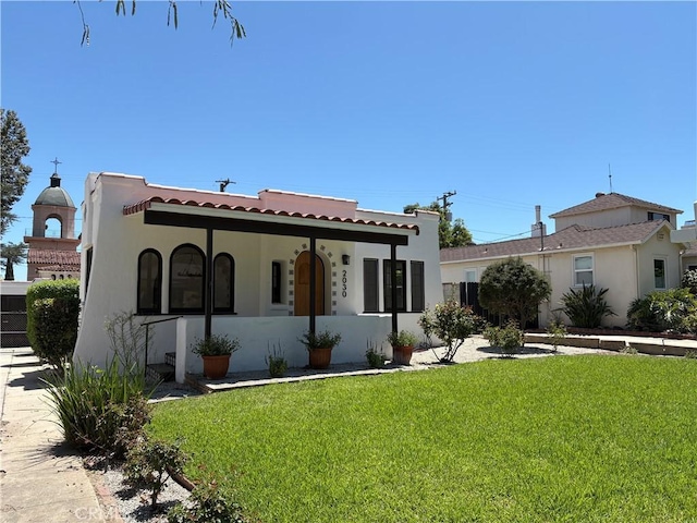 2030 Jefferson Dr, Pasadena, CA 91104 - mediterranean / spanish house with stucco siding, a front yard, and a tiled roof