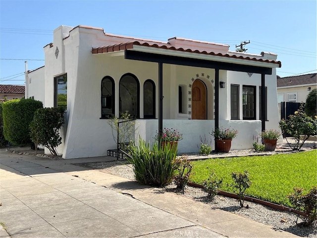 2030 Jefferson Dr, Pasadena, CA 91104 - mediterranean / spanish house with stucco siding, a front lawn, and a tile roof