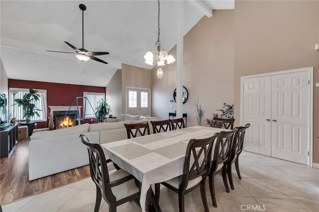 13329 Mission Tierra Way, Granada Hills, CA 91344 - dining room featuring a lit fireplace, light tile patterned floors, high vaulted ceiling, ceiling fan, and beamed ceiling